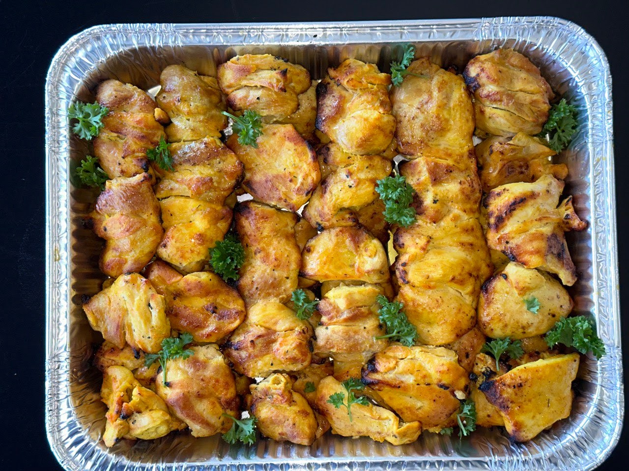 chicken kebob arranged on salald with garlic sauce