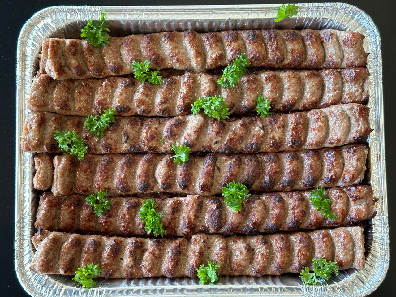 chicken kebob arranged on salald with garlic sauce